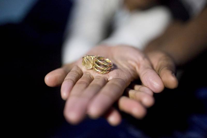 Tori Sisson holds out her and Shante Wolfe's wedding rings inside their tent near the Montgomery County Courthouse Sunday, Feb. 8, 2015, in Montgomery, Ala. Alabama Chief Justice Roy Moore sent a letter to probate judges Sunday evening ordering them to refuse to issue same-sex marriage licenses. (AP Photo/Brynn Anderson)