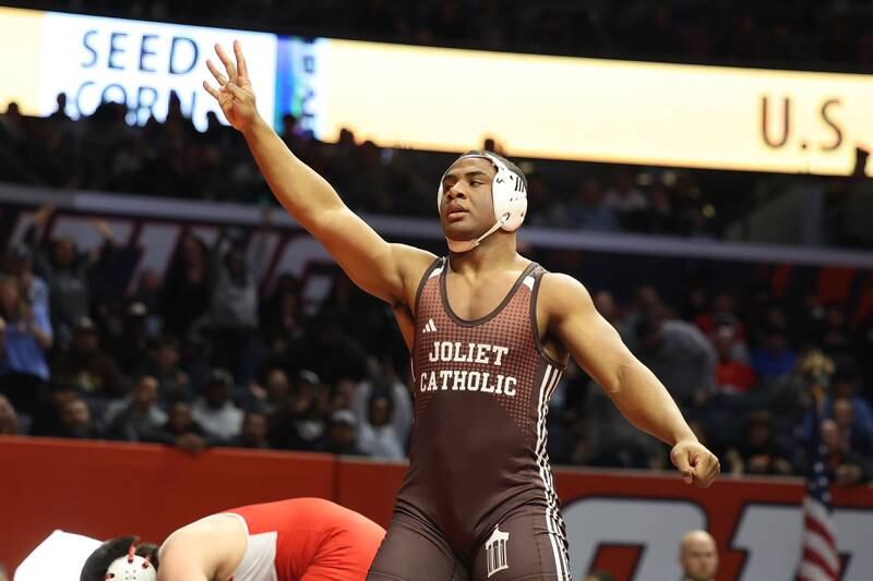 Joliet Catholic’s Dillan Johnson Hinsdale holds up four fingoers for his fourth state championship after his win over Central’s Marko Invanisevic in the 285-pound Class 3A state championship match on Saturday, Feb. 17th, 2024 in Champaign.