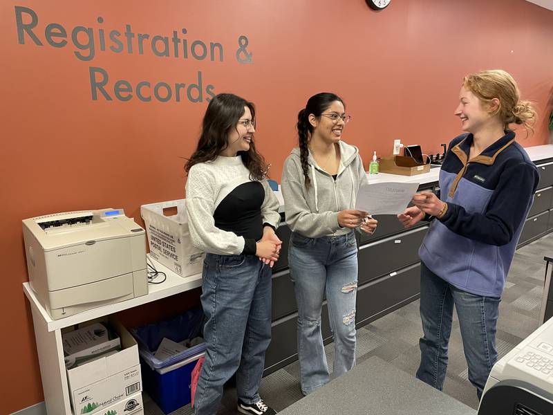 Students Keina Arteaga (left) and Rosy Rocha, of Mendota, discuss Illinois Valley Community Colleges late start classes with Maddison Gentry of the admissions office.