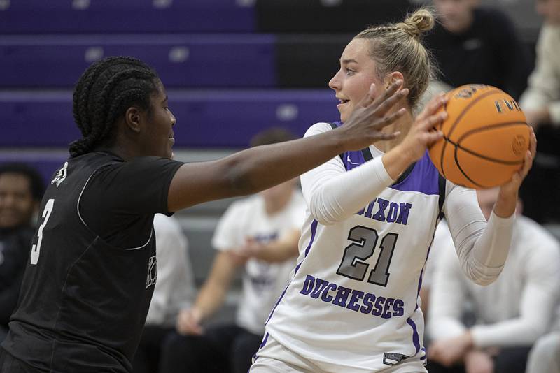 Dixon’s Reese Dambman looks to pass against Kaneland’s Amani Meeks Wednesday, Dec. 10, 2025.