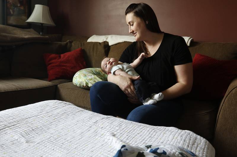 Brit Teson of Woodstock sits at home with her newborn, 4-week-old Barrett, on Monday, July 26, 2021 in Woodstock. Teson was hesitant to receive a COVID-19 vaccine while pregnant.