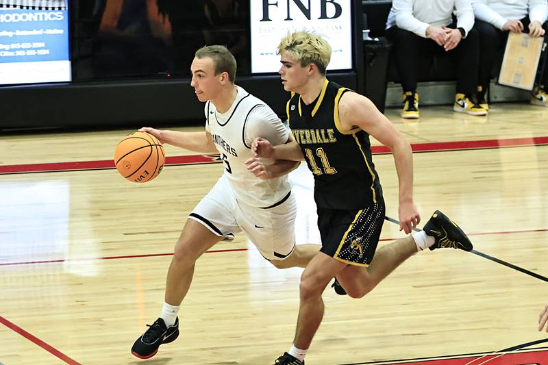 EP's Keegan Winckler tries to out hustle Riverdale's Brady Junis down the court Friday during the 2nd game of the Turkey Shootout Tournament in Prophetstown.