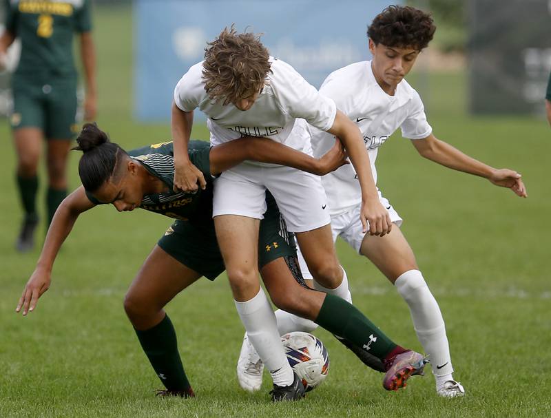 Crystal Lake South's Ali Ahmed battles with Huntley's Jonas Brown and Elias Ramon (right) for the ball during a Fox Valley Conference soccer match on Thursday, Sept. 28, 2023, at Crystal Lake South High School.