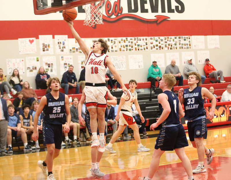 Hall's Greyson Bickett runs in for a layup against Bureau Valley's Landon Hulsing, Bryce Helms and Elijah Endress on Tuesday, Feb. 6, 2024 at Hall High School.
