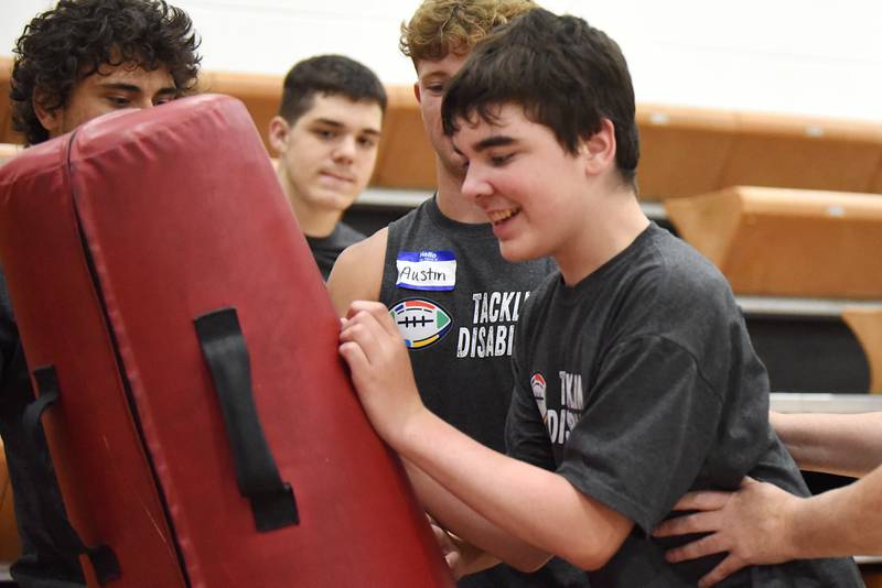 Oliver Watson hits a tackling dummy during Watseka's Tackling Disabilities football camp Saturday, July 26, 2025.