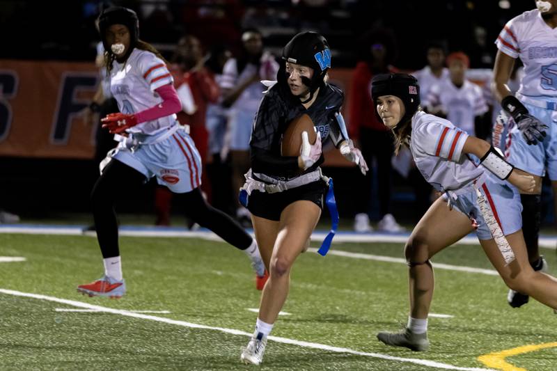 Willowbrooks's Elizabeth Pettinger picks up yardage during a varsity flag football IHSA State Quarterfinals game against Kenwood, held at Willowbrook High School on Oct. 17, 2025.