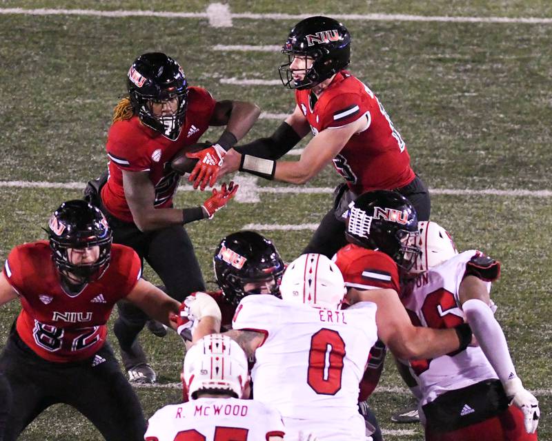 NIU QB Nevan Cremascoli, right, hands off the ball to running back Jaiden Credle during the third quarter Wednesday Nov. 16th while taking on Miami of Ohio at Huskies Stadium in DeKalb.