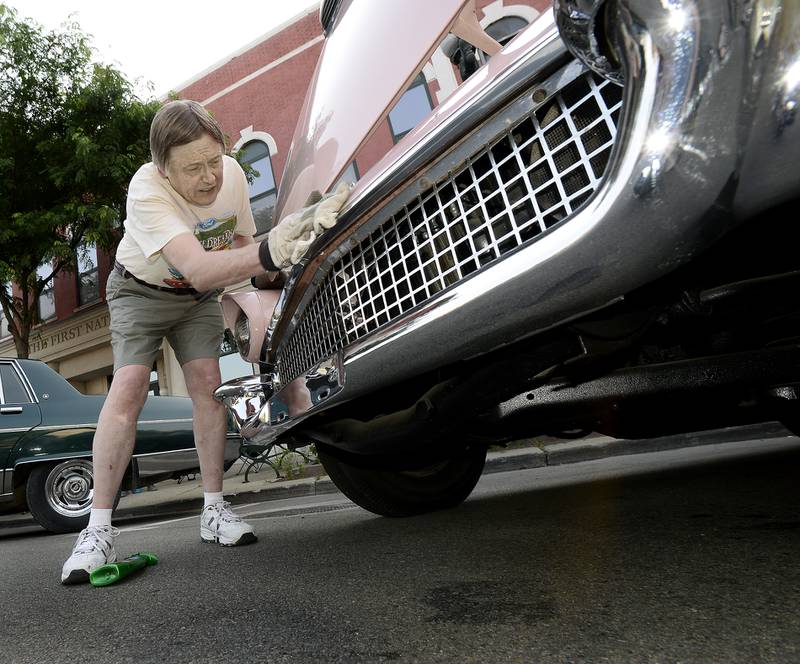 Dennis Day, of Ottawa, polishes up his 1957 Ford Thunderbird on Friday, June 16, 2023, during the annual Ottawa Cruise Night.