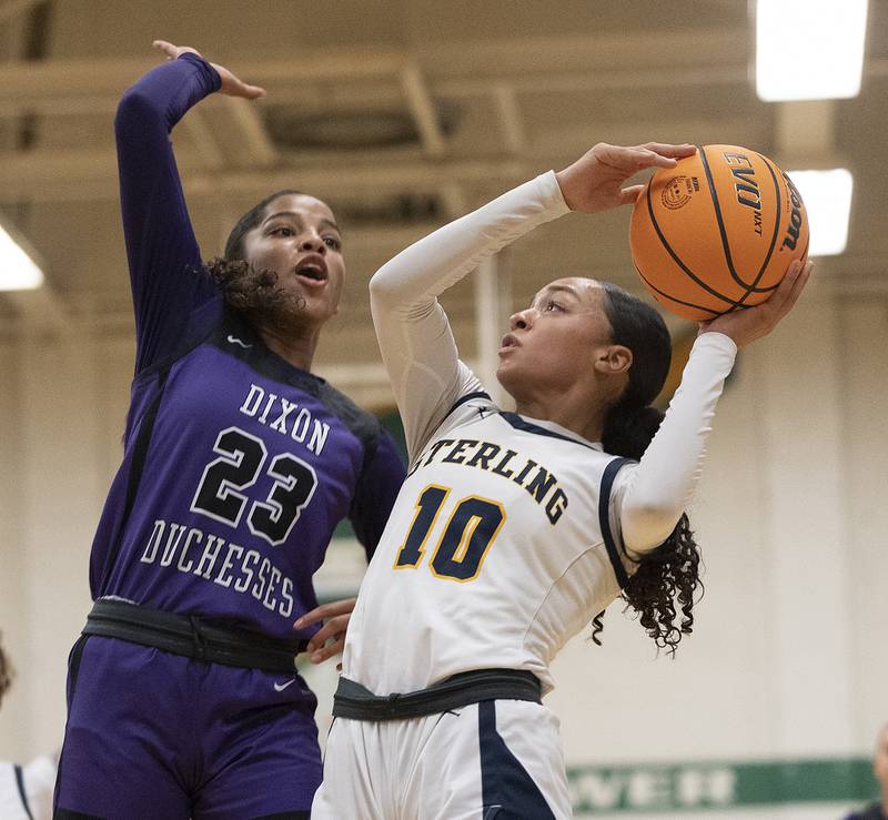 Sterling’s Nia Harris puts up a shot against Dixon's Ahmyrie McGowan Thursday, Feb. 27, 2025, during the Class 3A girls Sectional title at Rockford Boylan High School.