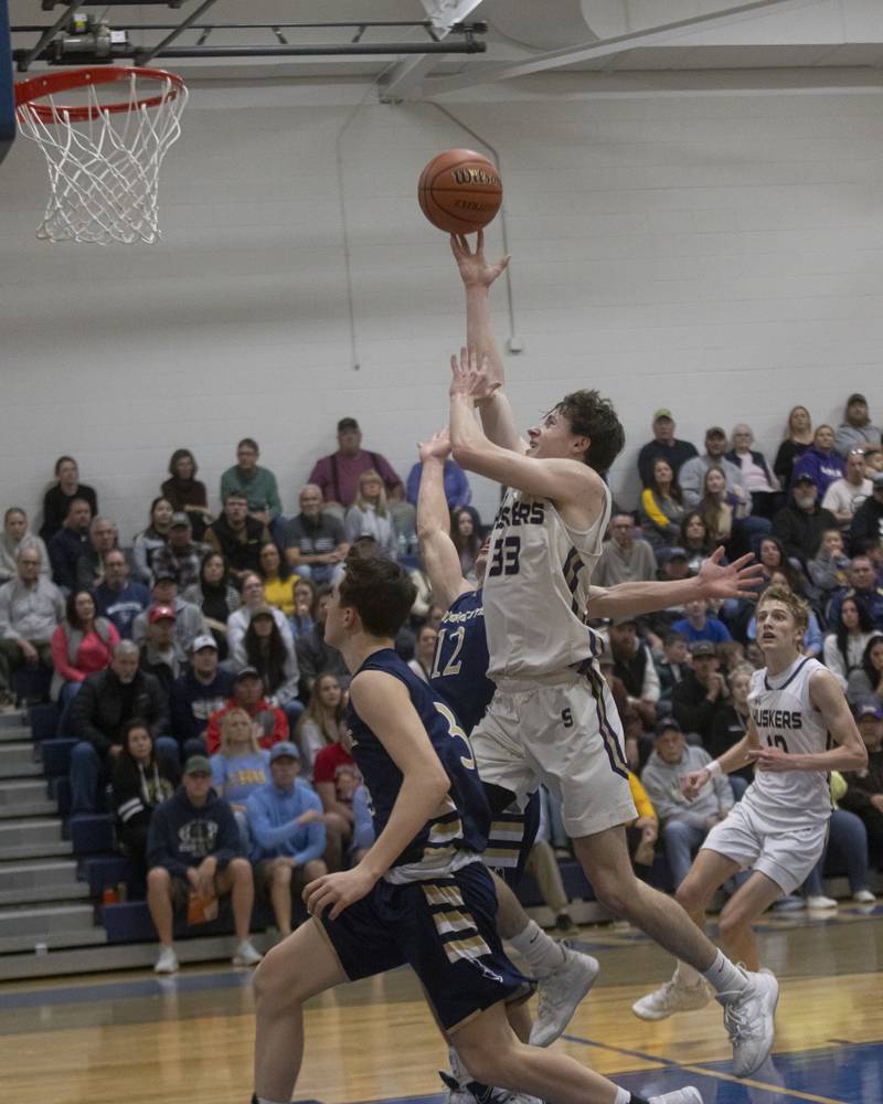 Hunter Staton of Serena drives his way through Marquette defense to the basket during the IHSA Class 1A boys basketball Regional Championship at Serena High School on February 23, 2024.
