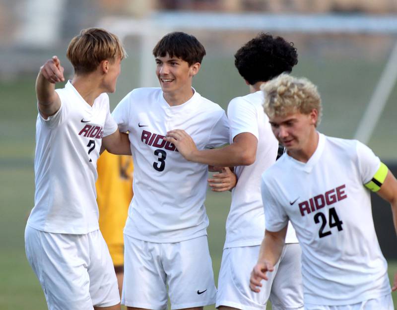 Prairie Ridge’s Trenton Pavoris, center, and the Wolves celebrate their second goal in varsity soccer at Jacobs High School in Algonquin on Thursday, Sept. 18, 2025.