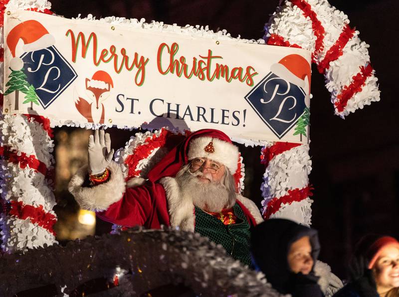 Santa waves to spectators while bringing the Holiday Homecoming Electric Christmas Parade to a close in St. Charles on Saturday, Nov. 30, 2024.