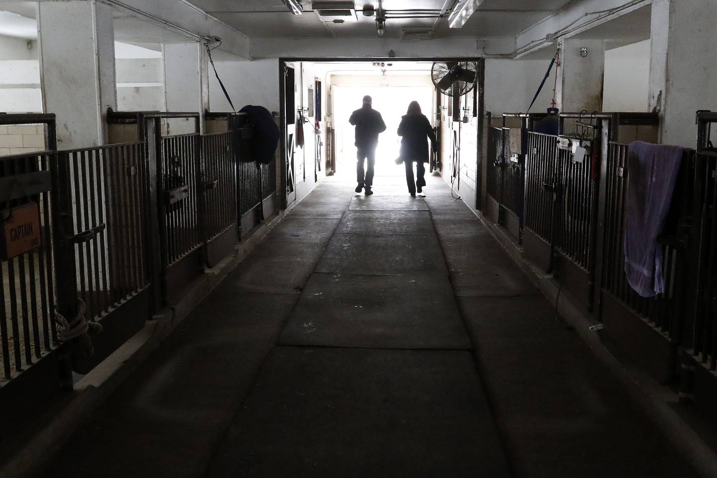 Bruce Johnson and Ann Somers walk through the stables on the first floor of the horse barn on Tuesday, Jan. 4, 2022 in the Village of Trout Valley.