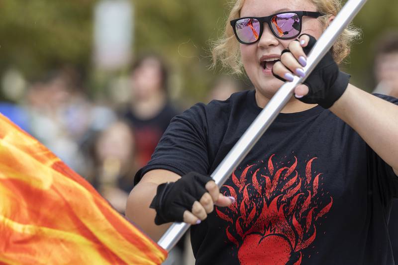 A Polo High School color guard member spins a firey flag during the Sterling/Rock Falls Fiesta Parade Saturday, Sept. 20, 2025. Celebrating Hispanic Heritage Month, the 72nd annual parade started in Rock Falls and ended in Sterling.