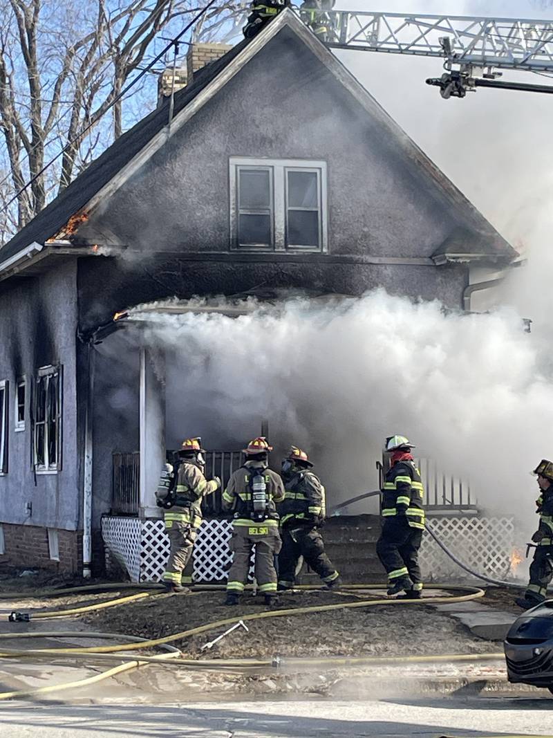 Flames and smoke pour from the windows and roof of a La Salle home Friday, Jan. 23, 2026, as firefighters battle the blaze in subzero temperatures.