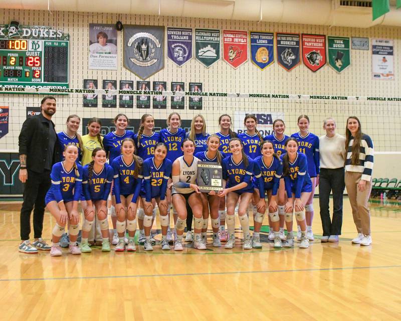 Lyons Township volleyball players pose for a photo after winning the regional title game over York on Thursday Oct. 30, 2025, held at York High School.