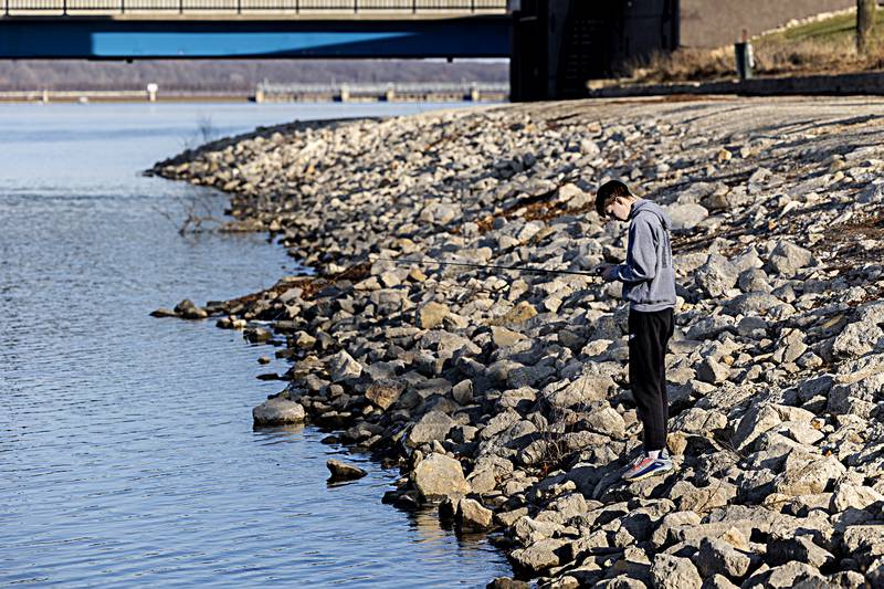 Aalin Schmidt fishes along the banks of the lower dam Wednesday, Dec. 20, 2023 in Rock Falls.The mild weather was great for fishing but bad for a potential white Christmas.