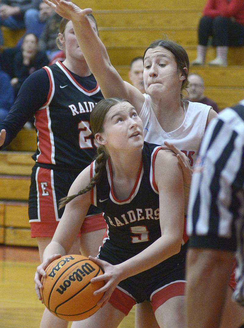 Earlville’s Bailey Miller eyes the basket as Streator’s Rhea Huey reaches to block in the 2nd period Saturday at Streator