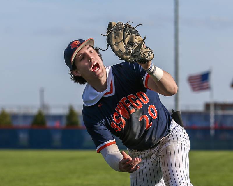 Oswego's Dylan King (20) comes up with a foul popup during baseball game between Plainfield South at Oswego on Monday, April 14, 2025 in Oswego.