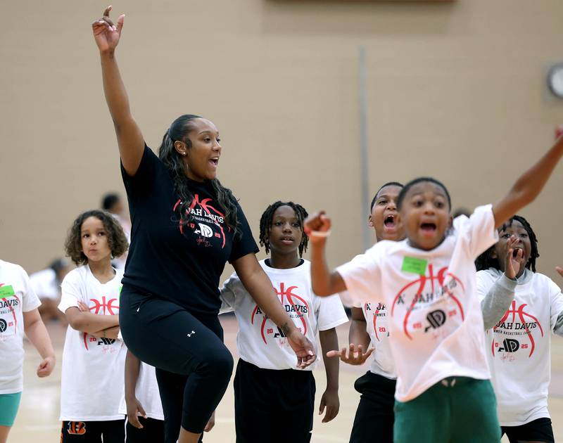 DeKalb native and former Northern Illinois University basketball player A'Jah Davis celebrates with her team during a relay race Saturday, May 24, 2025, at her A'Jah Davis Foundation Basketball Camp and Wellness Day at DeKalb High School.
