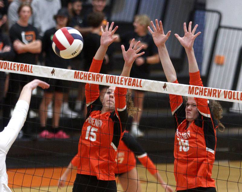 McHenry’s Sophie Zieba, left, and Ella Boland block against Crystal Lake South in varsity volleyball at McHenry Tuesday night.