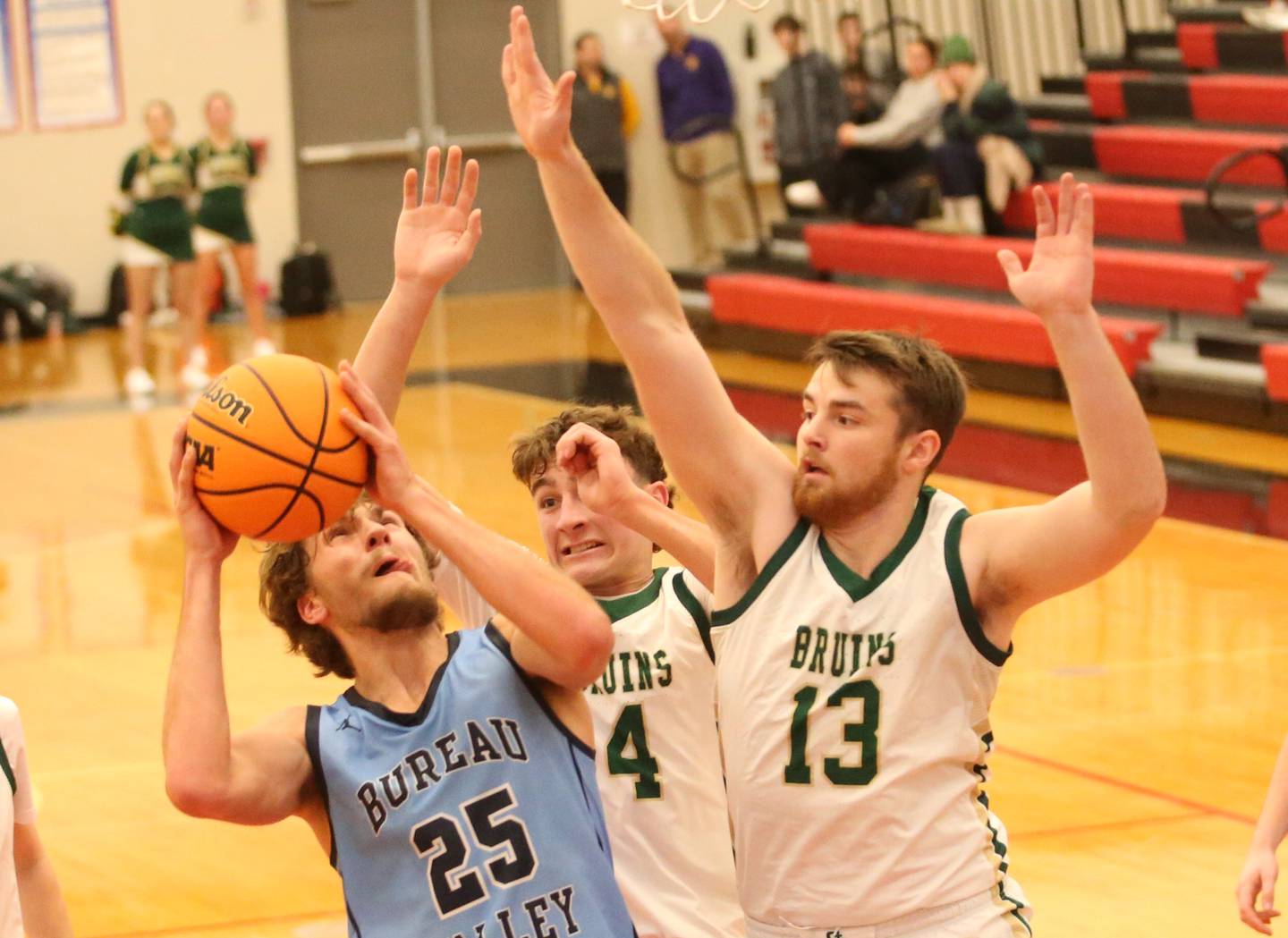 Bureau Valley's Landon Hulsing eyes the hoop as St. Bede players Gino Ferrari and Mason Ross defend during the 50th annual Colmone Classic on Thursday, Dec. 12, 2024 at Hall High School.