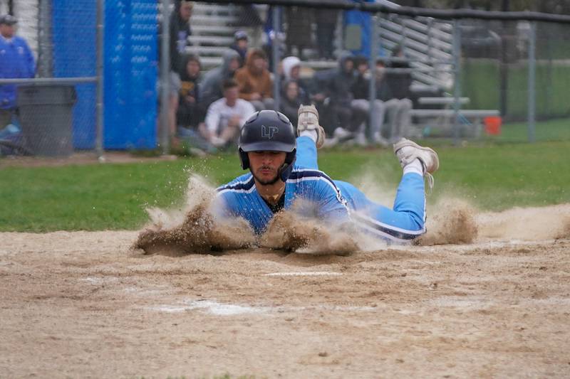 Lake Park's Derek Ittner (21) slides into home for a score against Geneva during a baseball game at Geneva High School on Wednesday, April 17, 2024.