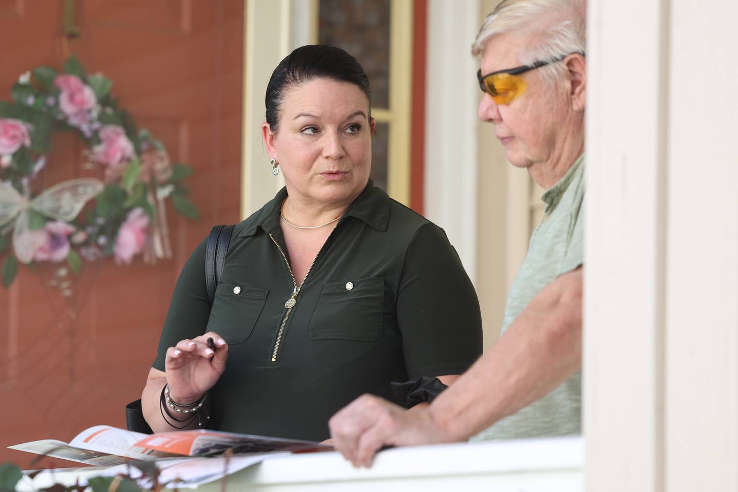 Maria Cedano, a realtor with ReMax, goes over paperwork with her client Wayne Galasinski. Wayne is looking to downsize and sell his home he has had since 2003. Wednesday, Aug. 10, 2022, in Crest Hill.