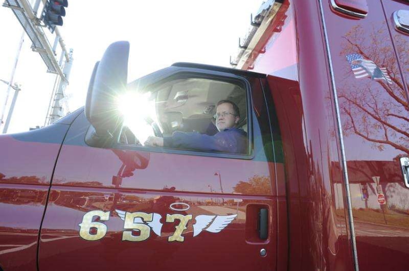 File photo - Fox River Grove Fire Capt. Jason Kedrok, who was a student on the bus struck by a train in 1995, drives an ambulance in 2015 with a 7 and an angel wing in memory of the seven students who died. Mark Welsh/mwelsh@dailyherald.com