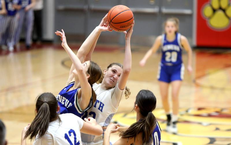 Geneva’s Hope Ieler (left) and St. Charles North’s Katrina Stack go after a rebound during a Class 4A Batavia Sectional semifinal game on Tuesday, Feb. 20, 2024.