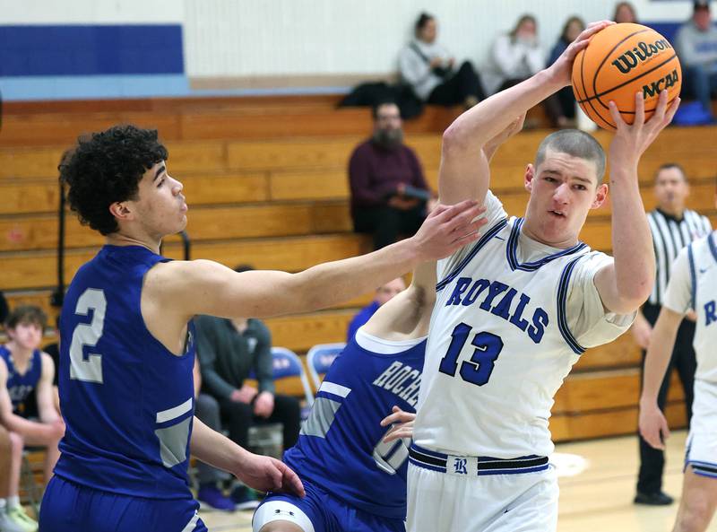 Hinckley-Big Rock's Jacob Orin pulls down a rebound in front of Rochelle Zell’s Ronen Ousley during their game Tuesday, Dec. 17, 2024, at Hinckley-Big Rock High School.