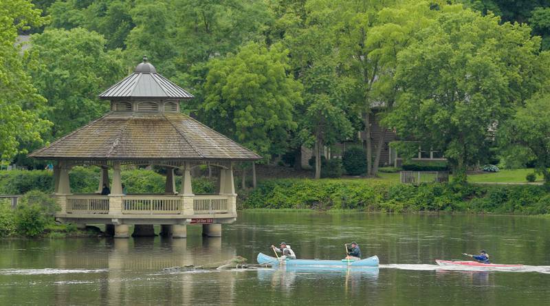 Racers approach the first portage at the Batavia dam during the annual Mid-American Canoe & Kayak Race along the Fox River on Saturday, June 1, 2024.