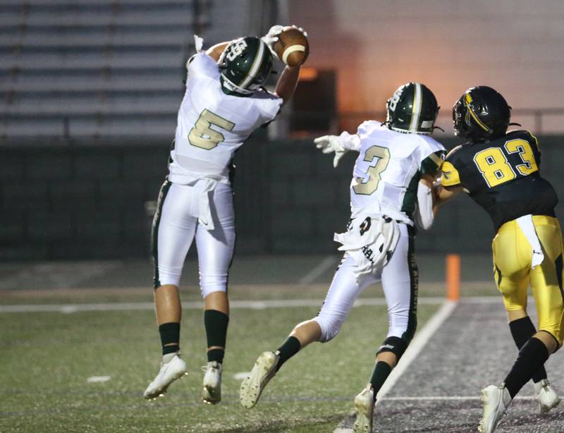 St. Bede's Casey Schaearer intercepts a pass intended for Tuscola's Zach Rennels as St. Bede's Hunter Savage (3) defends on Friday, Aug. 25, 2023 at Tucci Stadium  in Bloomington.