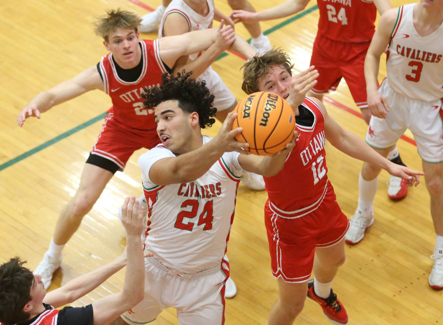L-P's Marion Persich grabs a rebound over Ottawa's Jack Carroll during the Class 3A Regional title game on Wednesday, Feb. 25, 2026 in Sellett Gymnasium at L-P High School.
