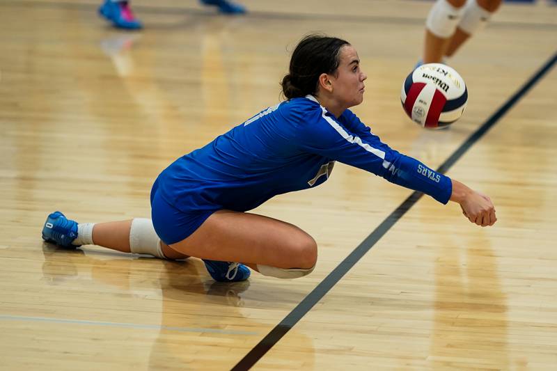 St. Charles North's Addison Kashuba (17) saves the ball on a serve from Rosary during a volleyball game at Rosary High School in Aurora on Monday, Aug 25, 2025.