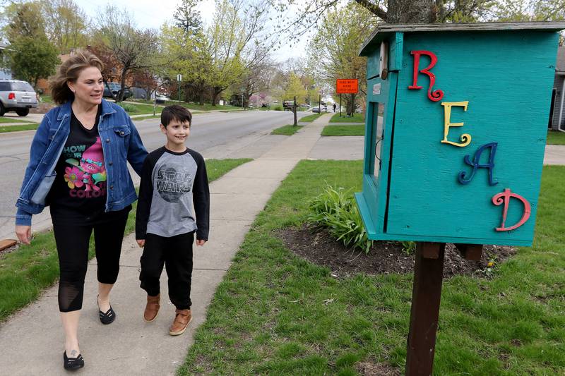 Chris Chirchirillo takes a walk with Jaxen Esparza, 8, down to the little free library at the end of her block on Saturday, April 24, 2021 in Lake in the Hills. Chirchirillo is one of 24 people to receive an outpatient robotic lung surgery at Northwestern Medicine and, four months later, is enjoying returning to normal activities.