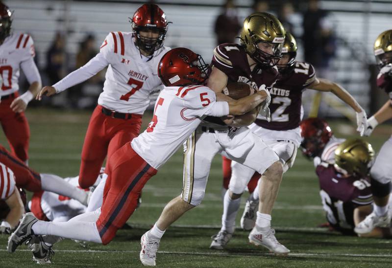 Huntley's Zach Rysavy tackles St. Ignatius' Jack Wanzung during a IHSA Class 8A second round playoff football game on Friday, Nov. 3, 2023, at St. Ignatius College Prep in Chicago.