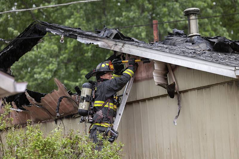 Firefighters work at the scene of a fire located in the 800 block of Avenue I Monday, April 27, 2026, in Sterling. Sterling, Dixon, Rock Falls, and other departments responded to the fire.