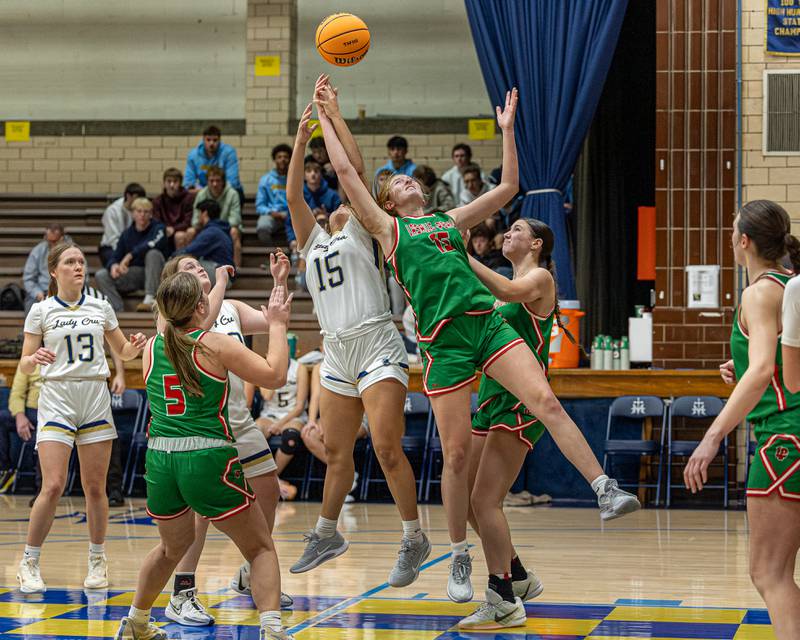 Maragret Boudreau (15) of LaSalle-Peru and Senya Mitre (15) of Marquette leap to catch rebound on Saturday, January 3, 2026 at Marquette Academy in Ottawa.