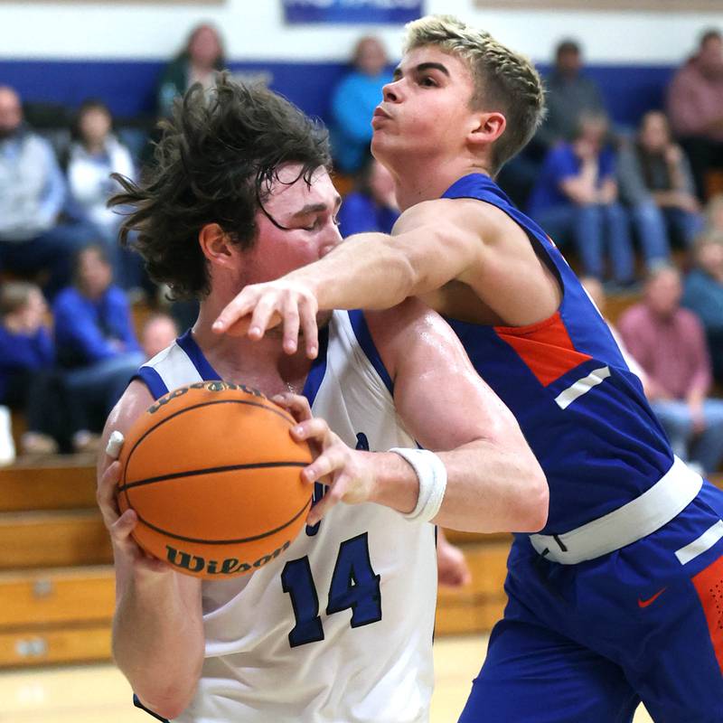 Hinckley-Big Rock's Martin Ledbetter (left) tries to keep the ball away from Genoa-Kingston's John Swineheart after a rebound during their game Tuesday, Jan. 7, 2025, at Hinckley-Big Rock High School.