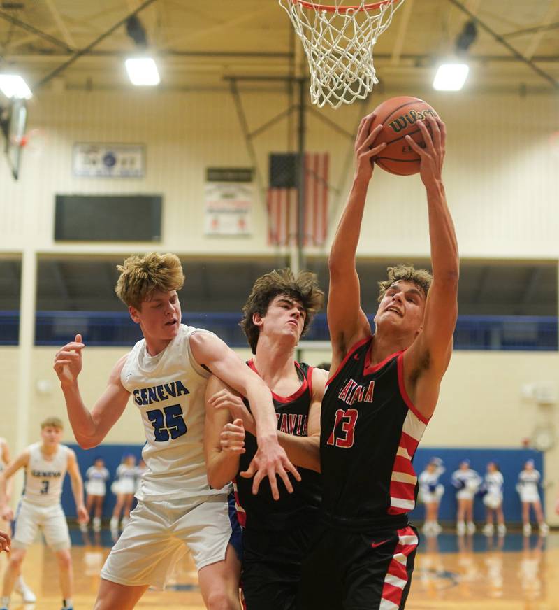 Batavia’s Isaac Wit (13) rebounds the ball against Geneva’s Hudson Kirby (25) during a basketball game at Geneva High School on Friday, Dec 15, 2023.