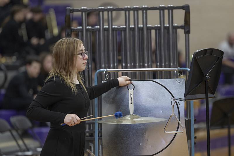 A seventh grade percussionist uses a sheet of metal to simulate thunder during the band’s rendition of “Red Thunder” Friday, Feb. 13, 2026.