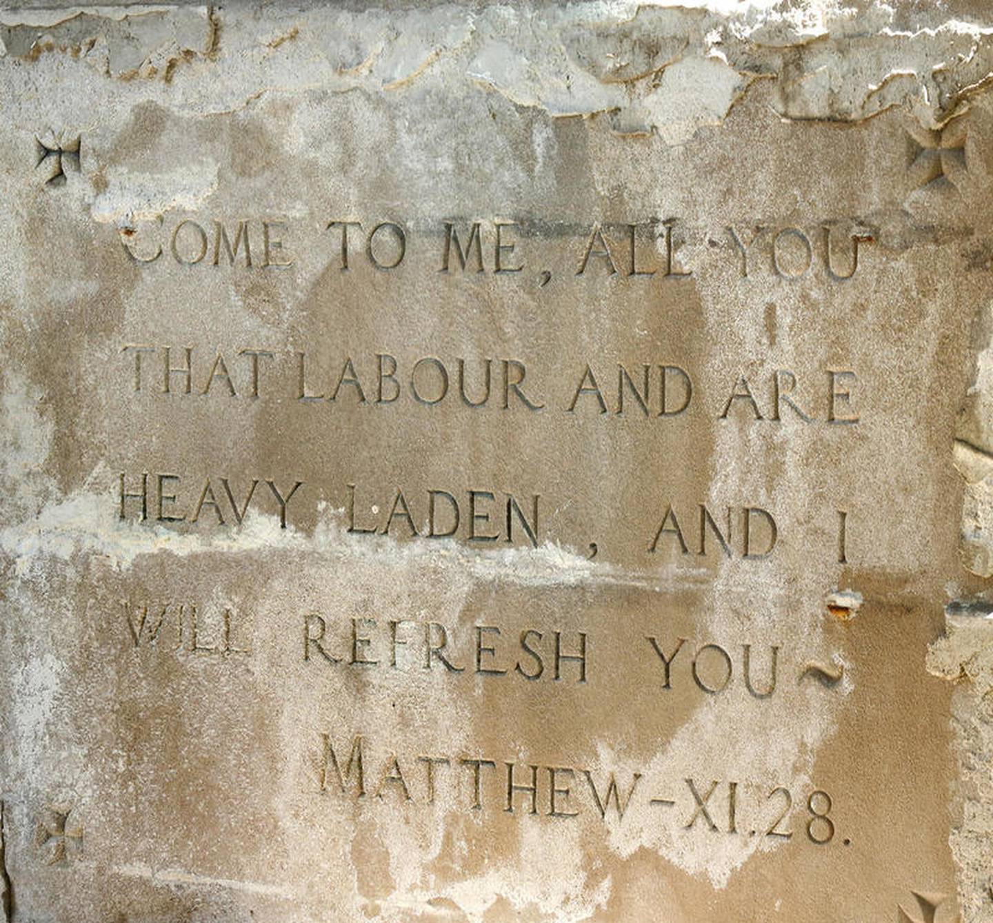 Scripture etched into the old St. Mary's Hospital building at 145 Fisk Ave. in DeKalb Tuesday July 10, 2018. The building served as a hospital after its construction in 1922 until 1965, and has also housed office space and was the home to School District 428's administration until 1992.