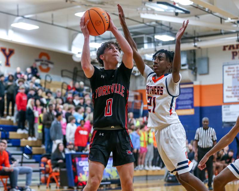 Yorkville's Gabe Sanders (0) goes up for a basket during their basketball game between Yorkville at Oswego, Tuesday Dec 10, 2024 in Oswego.