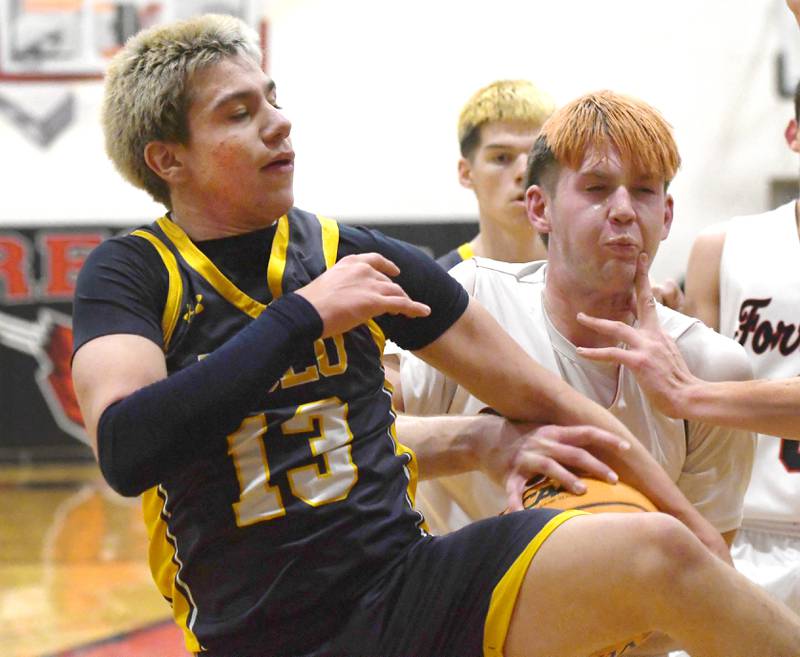 Polo's Eli Perez (13) and Forreston's Brennan Byers (31) battle for the ball on Saturday, Dec. 13, 2025  at the 64th Annual Forreston Holiday Basketball Tournament held at Forreston High School.
