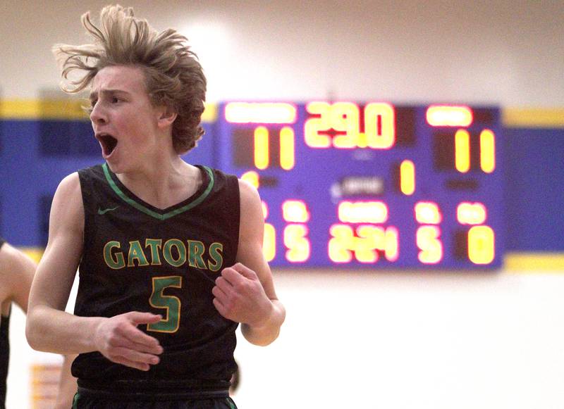 Crystal Lake South’s Carson Trivellini gets revved up early against Huntley in varsity basketball tournament title game action at Johnsburg Friday. Trivellini’s Gators fell to the Red Raiders in the title game.
