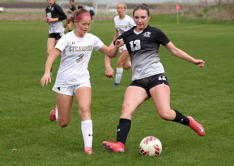 Kaneland's Kyra Lilly (right) tries to kick the ball by Sycamore's Marin Gautcher Wednesday, April 30, 2025, during their game at Kaneland High School in Maple Park.
