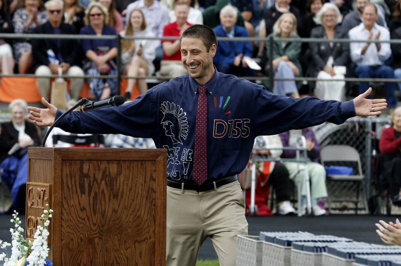 Cary-Grove Principal Neil Lesinski show off his shirt to the graduates during the graduation ceremony for the class of 2023 at Cary-Grove High School in Cary.