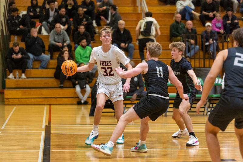 Yorkville's Joey Jakstys  goes baseline against Glenbard West's Chase Cavan on Friday Dec. 26,2025 at the 51st. Annual Jack Tosh Holiday Tournament in Elmhurst.