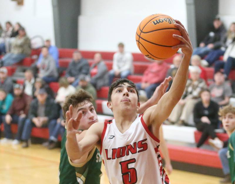 LaMoille's Braiden Fischer eyes the hoop to score over St. Bede's Gino Ferrari on Tuesday, Feb. 11, 2025 at LaMoille High School.